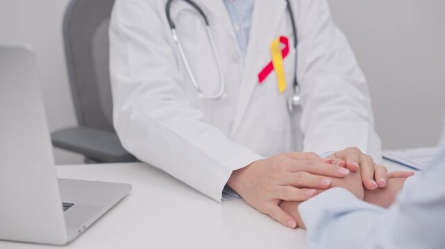 World hepatitis day awareness month, 28 July. doctor holding patient hand to comfort and support with empathy. Red and Yellow ribbon for Liver cancer, Jaundice, Cirrhosis, Failure, Enlarged