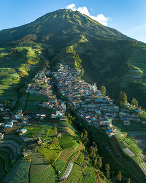 Aerial view of Nepal Van Java, a village on the slopes of Mount Sumbing with colorful houses, terraced fields, and lush mountain scenery in Kecamatan Kaliangkrik, Jawa Tengah, Indonesia.