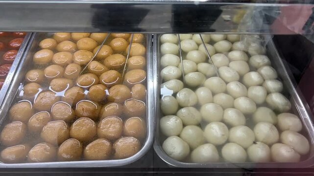 A magnificent display of authentic Bengali mishti, featuring spongy white rosogollas, saffron-infused kamala bhog, and rich, syrup-soaked gulab jamuns, West Bengal, India.