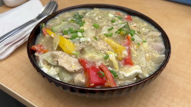 A vibrant platter of authentic Indo-Chinese mix chowmein, loaded with tender shredded chicken, scrambled egg, and crisp colorful bell peppers, India.