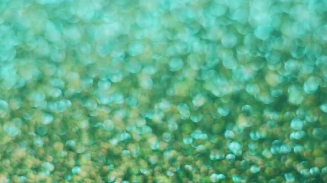 Blur confetti light. Shimmering texture. Green blink leak cyan beam reflection. Color abstract scintilla luminosity bokeh background.