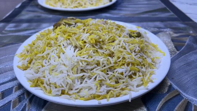 Kolkata style chicken biryani with large leg piece and salad; traditional aromatic basmati rice, iconic calcutta biryani potato, chicken drumstick platter, and Indian street food.