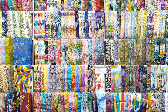 The store features many colorful scarves and shawls with various patterns and patterns.