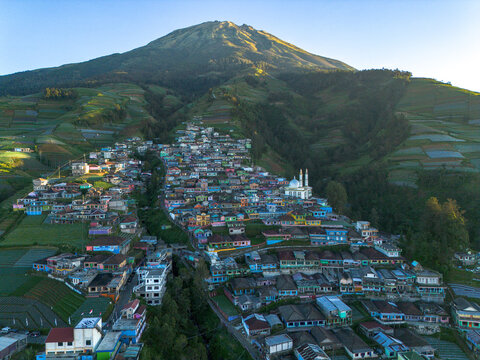 Aerial view of Nepal Van Java, a colorful village nestled on the slopes of Mount Sumbing with terraced vegetable fields and a mosque in Kecamatan Kaliangkrik, Jawa Tengah, Indonesia.