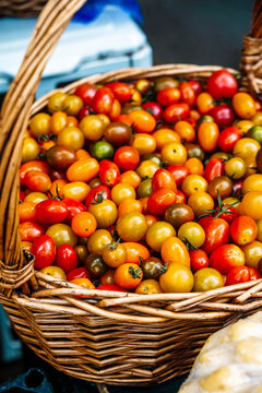 Wicker basket filled with colorful cherry tomatoes