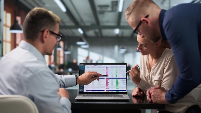 Billing Analyst And Team Reviewing Coding Spreadsheets
