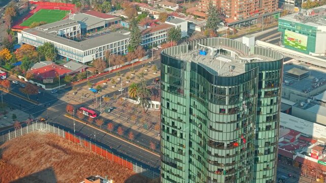 Aerial View of Modern Curved Glass Skyscraper and City Traffic in Santiago Chile