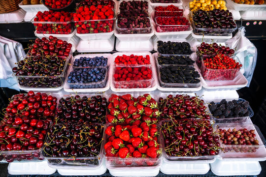 Vibrant market display of seasonal berries. 