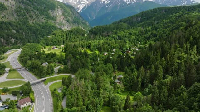 Aerial view of road N205 and hillside homes in the mountains of France, summer