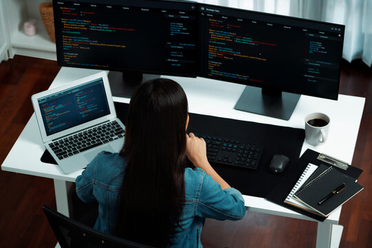Top view young Asian IT developer creating with typing online information on pc with coding program data of website application, wearing jeans shirt. surround by safety analysis two screen. Stratagem.