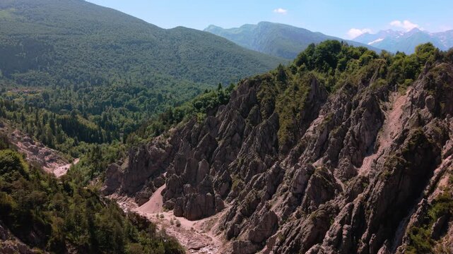 Rugged mountain slopes and deep canyons in the Friulian Dolomites. Cinematic wilderness landscape.