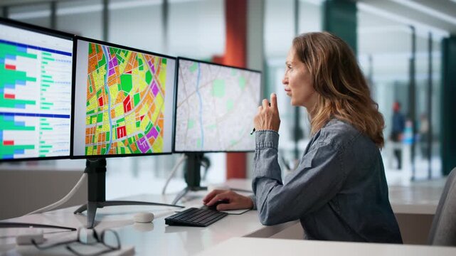 Urban Planner Studies Zoning Map On Multiple Screens