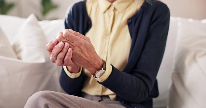 Home, hands and senior person with joint pain for arthritis inflammation, chronic illness or massage. Retirement, pensioner and finger stiffness on sofa with discomfort, rheumatism risk and grip loss