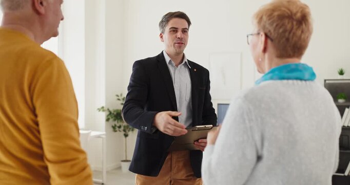 Seniors couple advisor consultation meeting strengthens clients trust. They discuss retirement planning, check documents, and set shared goals together. Clear retirement guidance for couples.