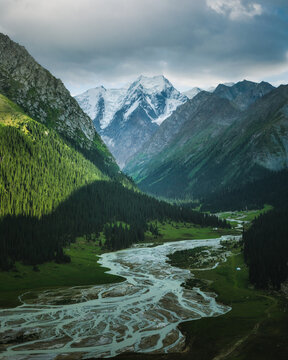 Aerial view of Boris Yeltsin Peak above the Jety - Oguz valley, with a glacial river, dense pine forests, and mountain slopes Jety - Oguz, Issyk-Kul Region, Kyrgyzstan.