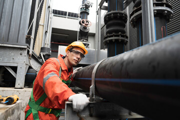 Male engineer working and inspecting HDPE pipe and fittings for cooling towers, Valve system. Pipe...