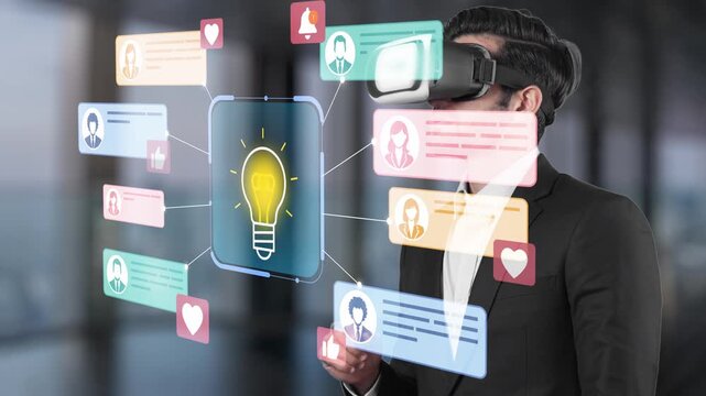 Professional man using virtual reality headset in a modern office while interacting with colorful digital interface and idea icons representing innovation and communication. Entropy.