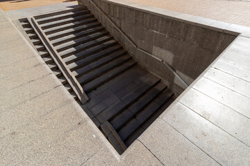 Obraz premium Wide angle view of concrete underpass stairs and ramp leading underground.