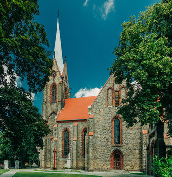 Wide angle of 19th century Catholic Christian stone church, Europe, Poland.