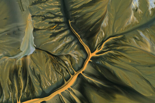 Aerial abstract surreal natural patterns above. Colorful chemical mining leach residues in decanting pond