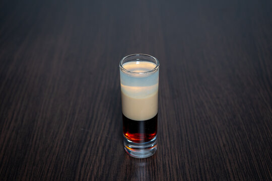 Layered B-52 Shot on Dark Wooden Table