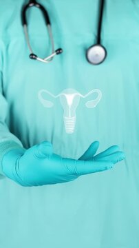 A gynecologist in green scrubs shows the white silhouette of the uterus. Concept to raise awareness about uterine health and the prevention of endometriosis, fibroids, and cervical cancer.