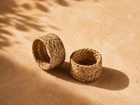 handwoven abaca napkin cuffs on clay plaster with cinematic soft light and clean negative space for premium stock background