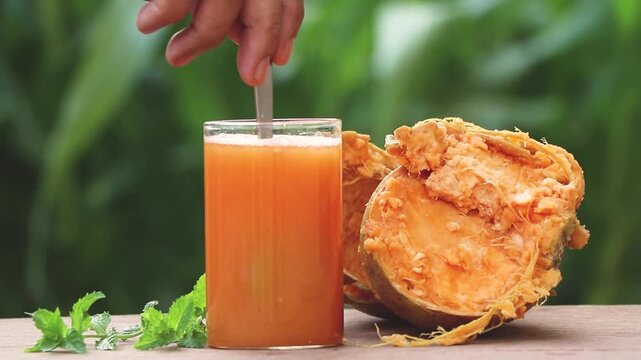 stone apple, or wood apple healthy juice with a natural green background. 