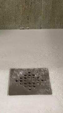Close Up Shower Water Flowing to Drain