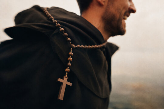 Rosary hanging from a monk robe during an outdoor walk