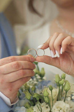 bride holding wedding rings