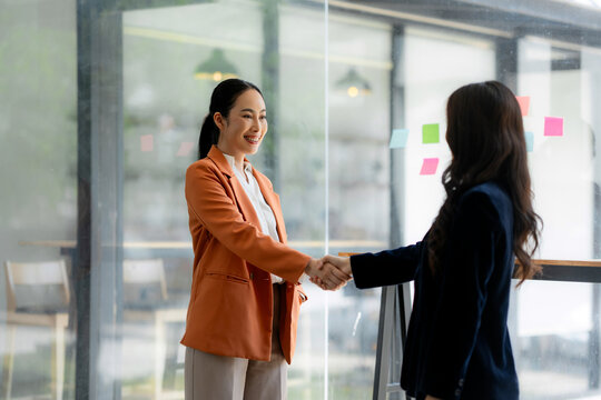 Businesswomen shaking hands after successful office meeting