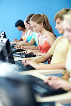 Education, typing and girl with computer at high school for knowledge, IT assignment or course. Teenager, students and class project with desktop for learning software, academic development or study