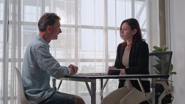 Human resources manager interviewing senior male candidate