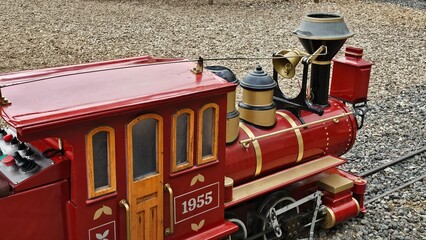 Colorful miniature train ride for children at an amusement park, featuring a classic locomotive design, family entertainment, and fun outdoor recreation. © mrbudiarto