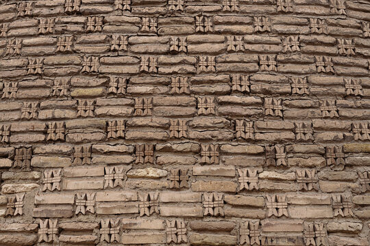 Decorative brickwork detail of the Kalyan minaret in Bukhara with carved cross-shaped ornamental inserts. Ideal for architectural texture backgrounds and heritage publications.