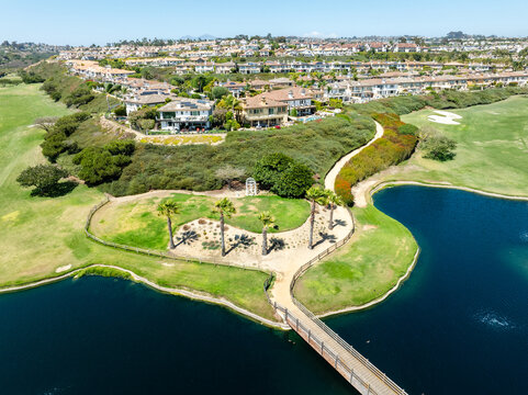 Luxury homes next to a sunny golf course