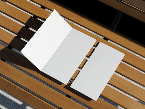 Blank White Flat Lay Folded Brochure Paper Mockup on Outdoor Wooden Bench 3D Render