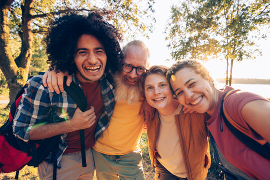 Diverse friends enjoying nature together during sunset