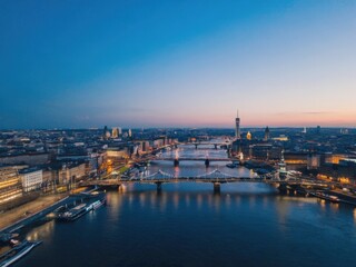 Fototapeta premium Aerial river cityscape at blue hour