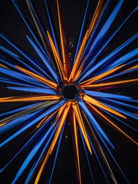 Blue Orange Light Trails Radiating from Center on Black Background