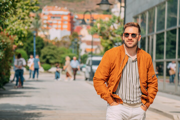 Fototapeta premium Casual man walking through the city