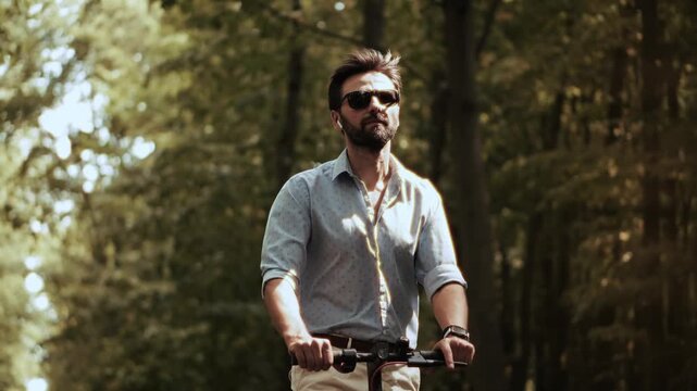 Riding Electric Scooter In Summer Green Forest. Eco Friendly Urban Transport. Individual Mobility 