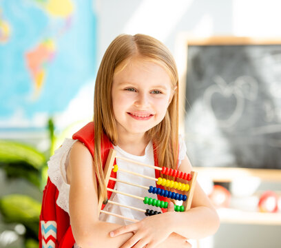 Happy First Grade Student Holds Bright Abacus