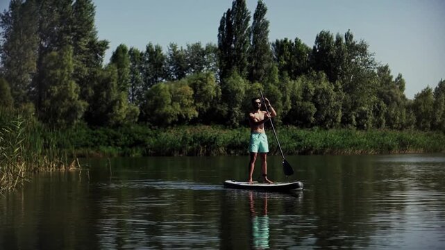Athletic Surfer Balancing On Stand Up Paddleboard On Calm River Water Surface. Summer Water Activities