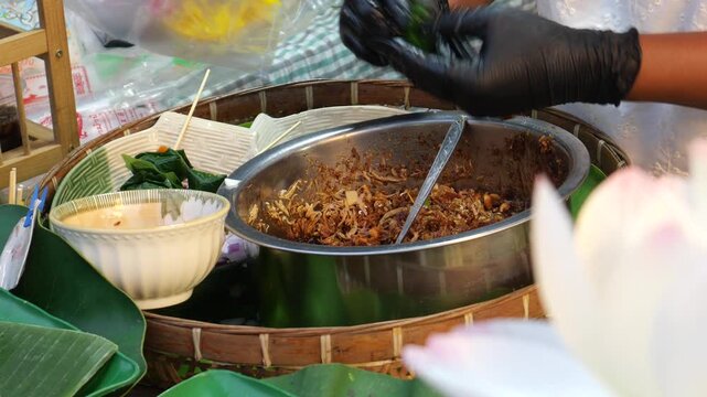 Making Miang Kham (traditional Southeast Asian herbal snack from Thailand and Laos), Traditional Thai snack. It&rsquo;s a snack containing different ingredients of herbs and vegetables. It helps balance the