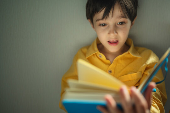 Curious student reading a fascinating book indoors