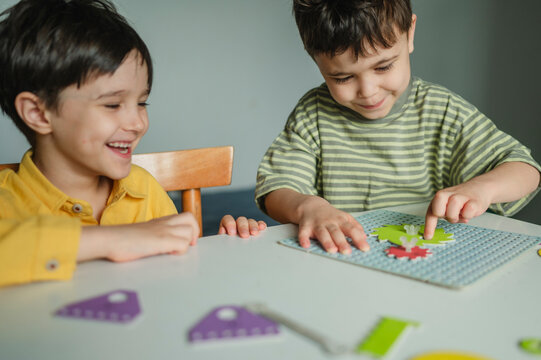 Friends learning mechanics with constructor toy at home
