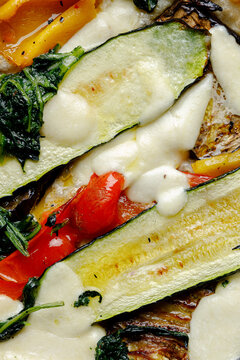 Texture of craft pizza with baked vegetables and cheese.
