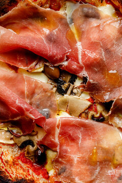 Texture of pizza with ham salami prosciutto close-up